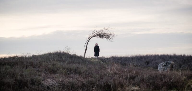 Hilary Hobson as foreboding woman standing under tree in Doctor Who, "73 Yards