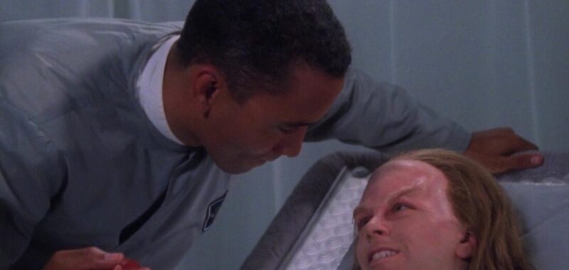 Dr Franklin hands a patient a "glopet egg" in a scene from Babylon 5: Believers